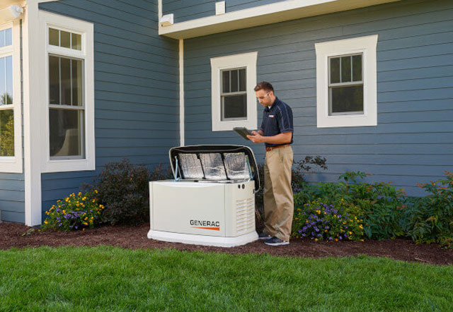 man servicing Generac Generator outside home