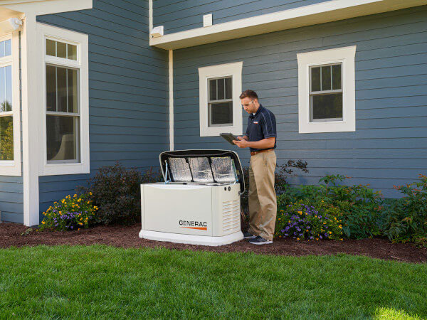 Man inspecting Generac Generator outside home